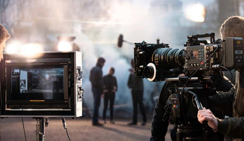 A group of people are filming a movie in front of a camera.