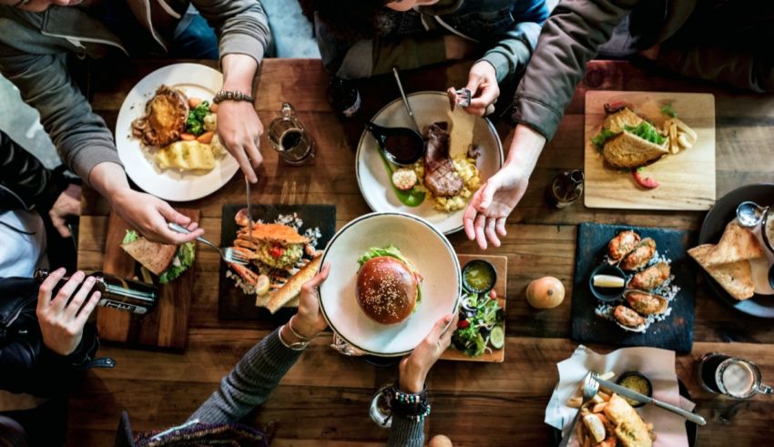 A group of people sitting around a table eating food.