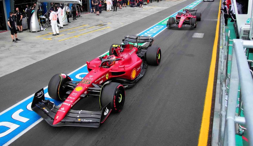 The ferrari f1 car is driving down the track.