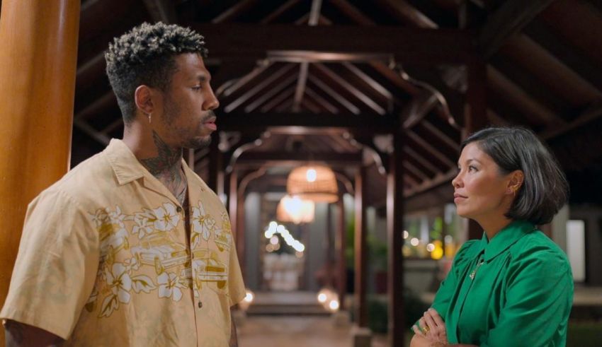 A man and woman standing next to each other in a hallway.