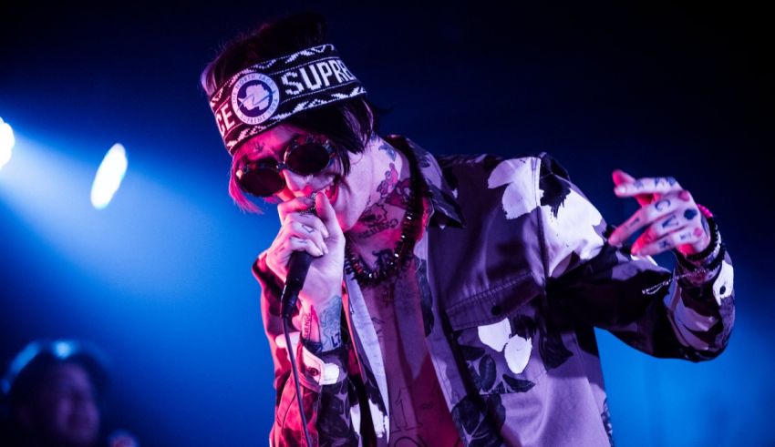 A man in a camouflage shirt singing into a microphone.