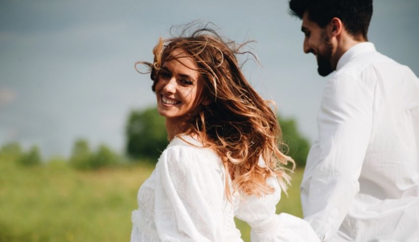 A man and woman are walking in a field.