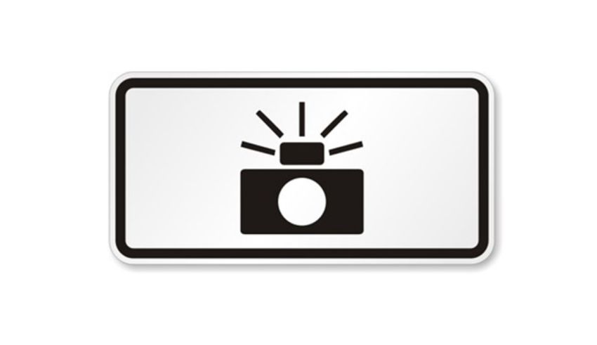 A black and white sign with a flashing light.