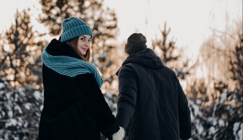 A couple holding hands in the snow.