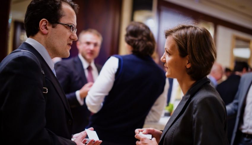 A man and woman talking at a business event.
