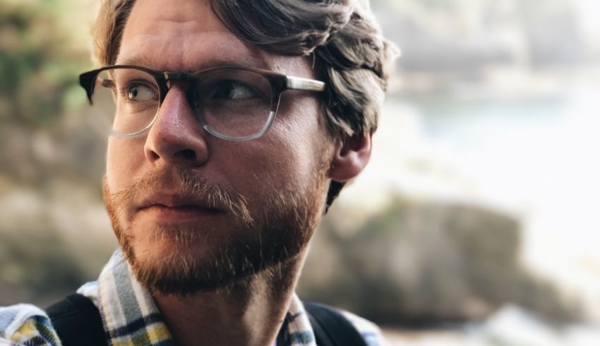 A man looking up with glasses.