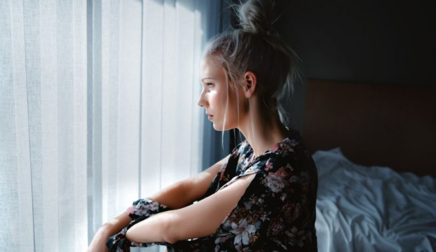 A young woman looking out of a window.