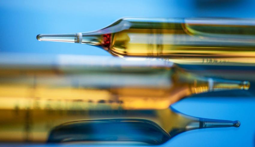 A group of syringes on a blue background.