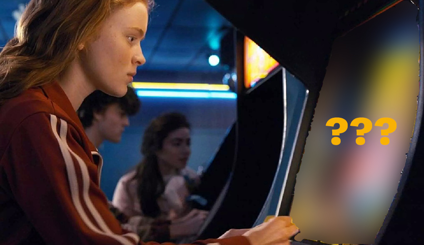 A girl is playing an arcade machine with a question mark on it.