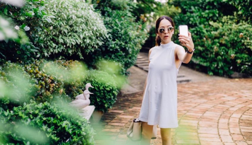 A woman taking a selfie in a white dress.