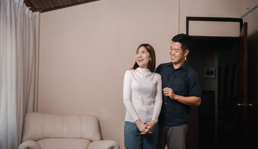 A man and woman standing in a living room.