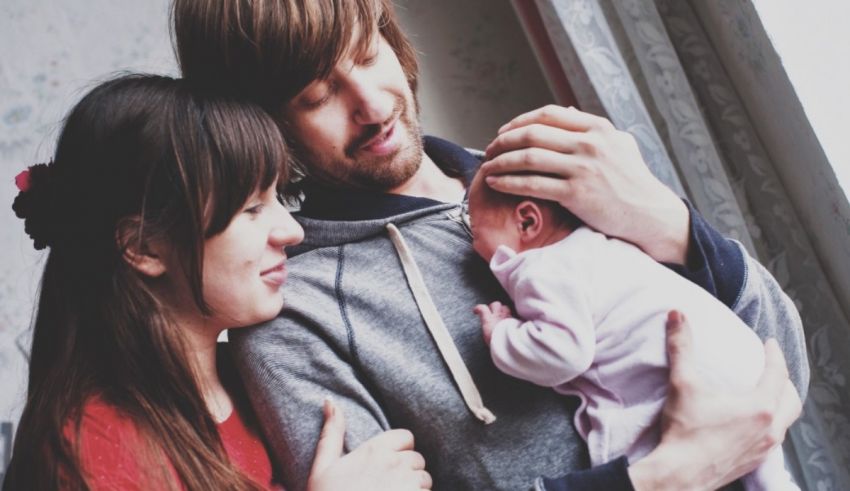 A man and woman holding a baby in their arms.