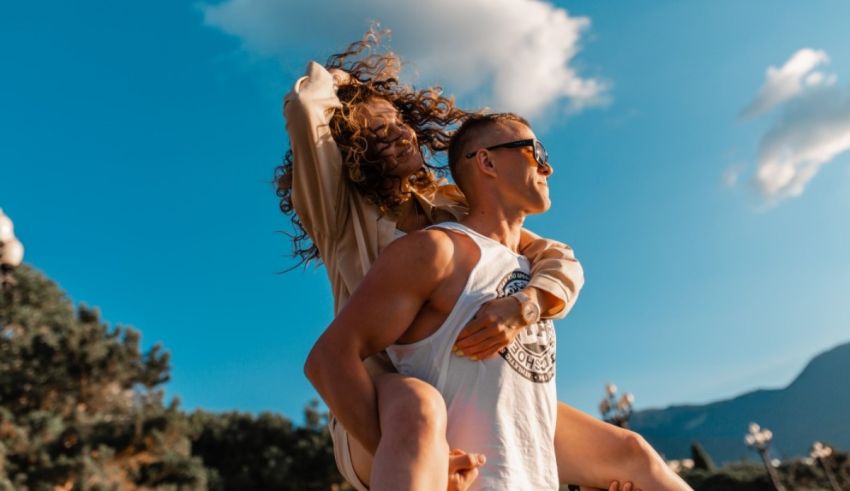A man is carrying a woman on his back in the mountains.