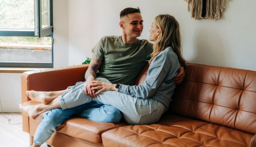 A couple sitting on a couch in their home.