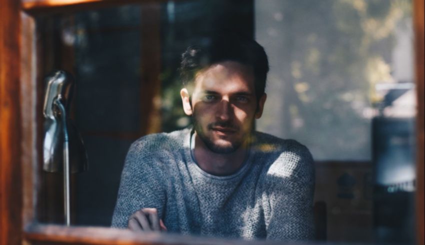 A man looking out of a window.