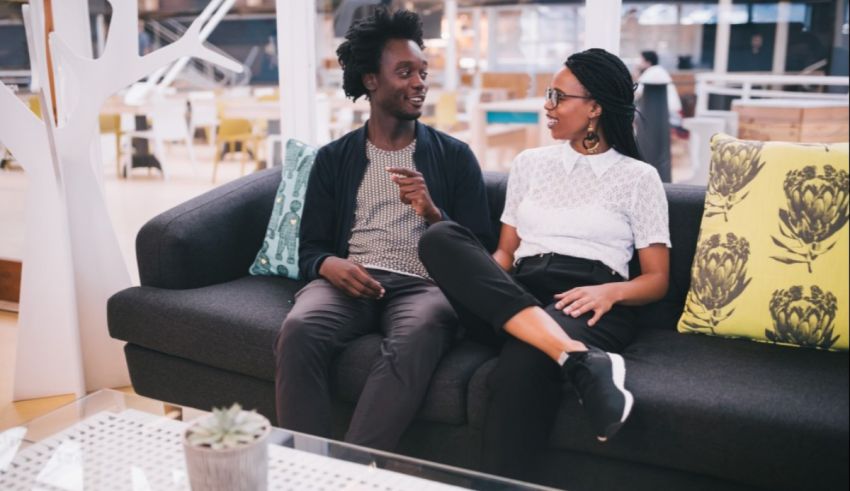 A man and woman sitting on a couch.