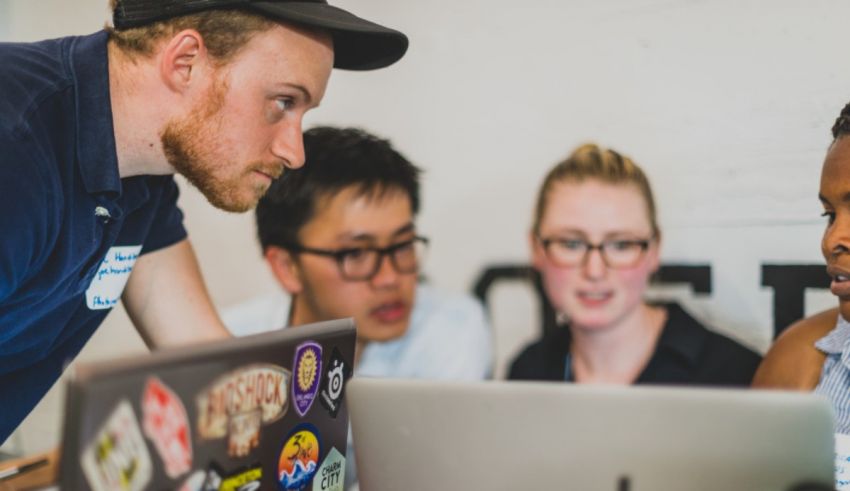 A group of people working on a laptop.