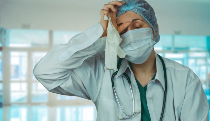 A female doctor in a hospital holding a handkerchief.