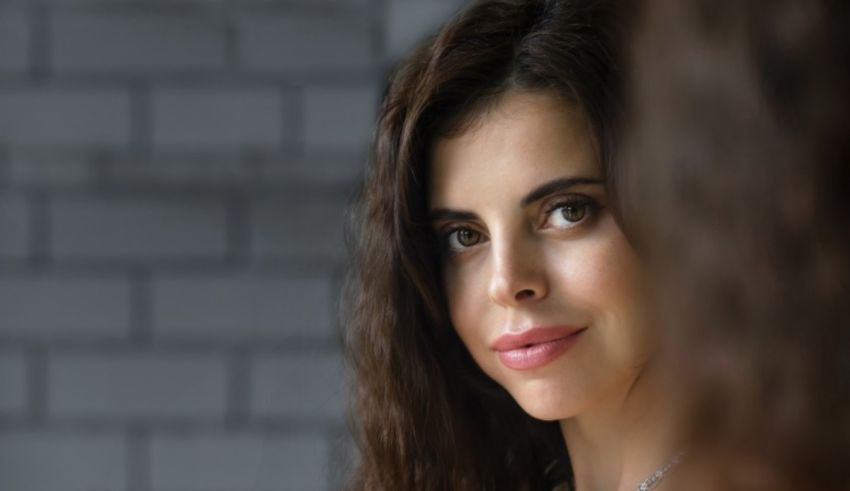 A woman looking at herself in the mirror.