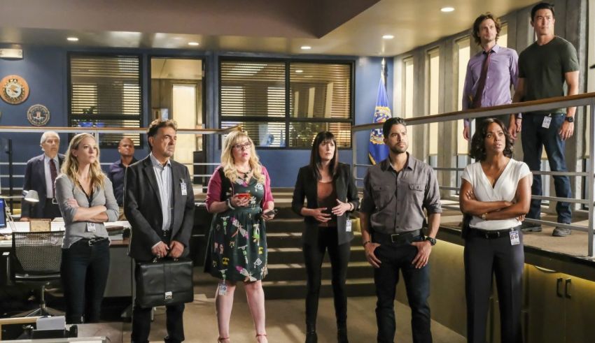 A group of people standing in an office.