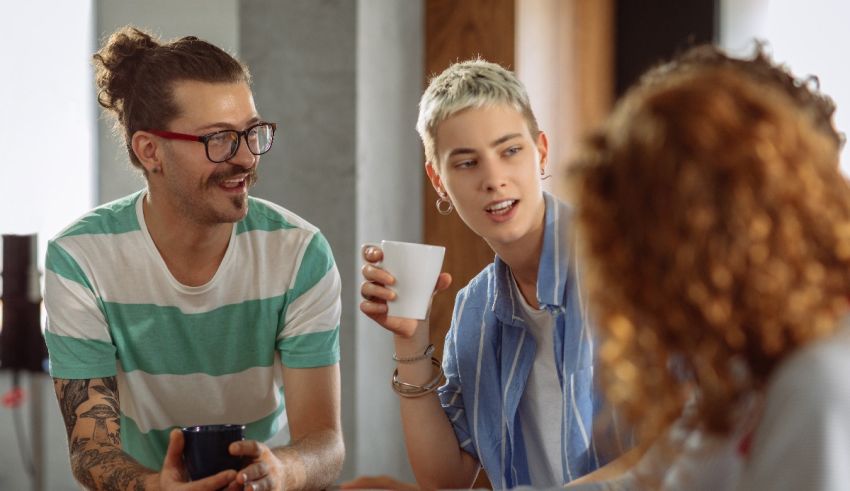 A group of people sitting around a table talking.