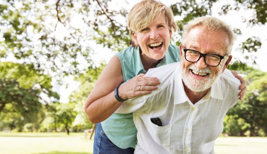An older man and woman are having a good time in the park.