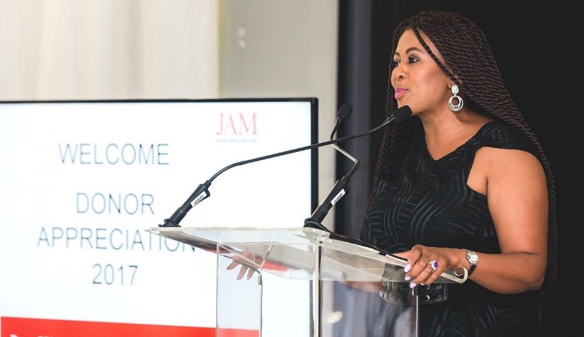 A woman giving a speech at a podium.