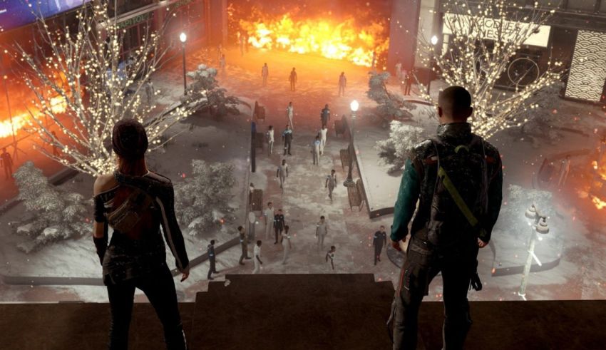 Two people standing in front of a burning building.