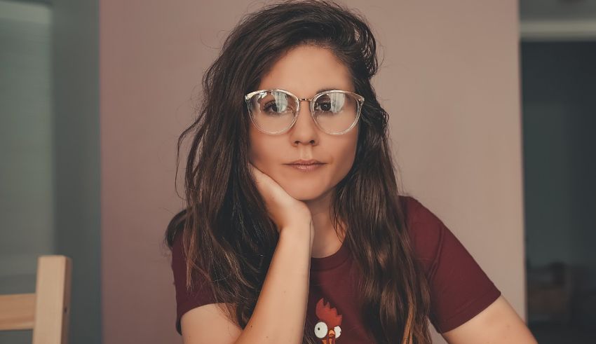 A woman with glasses sitting at a table.