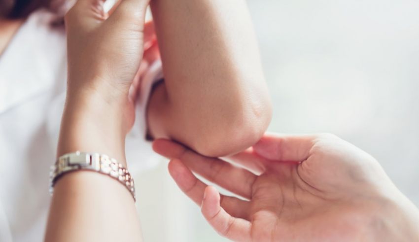 A woman's arm is being examined by a doctor.