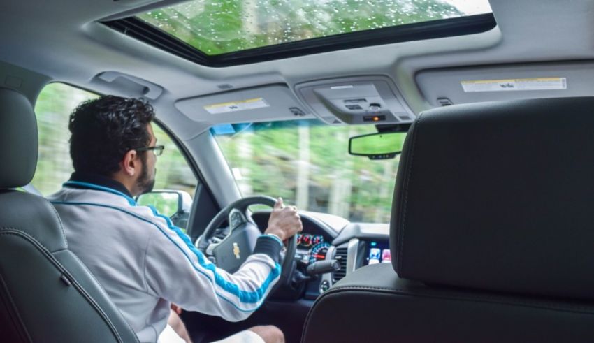 A man sitting in the back seat of a car.