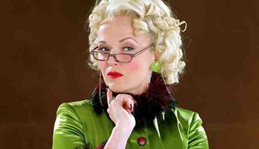 A woman wearing glasses and a green coat.