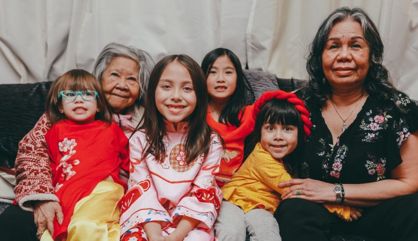 A group of asian women and children posing for a photo.