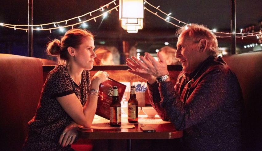 A man and woman sitting at a table in a restaurant.