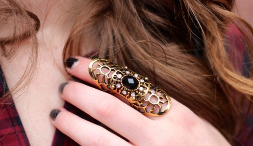 A woman's hand with a black ring on it.