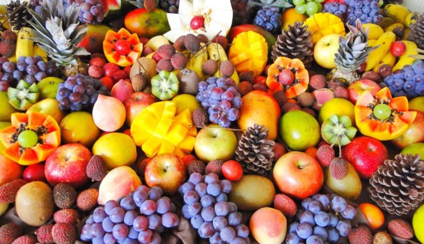 A variety of fruits are arranged in a pile.