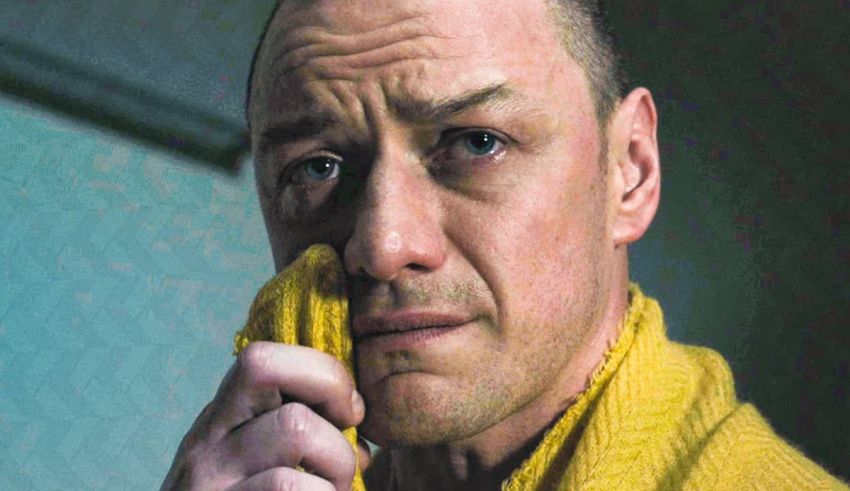 A man with a yellow towel on his face.