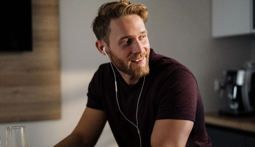 A man sitting at a table listening to music.