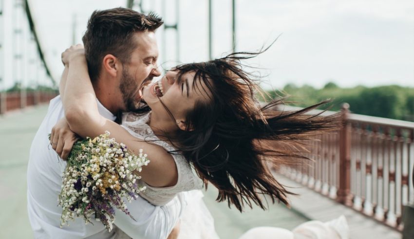 A man and woman holding flowers.