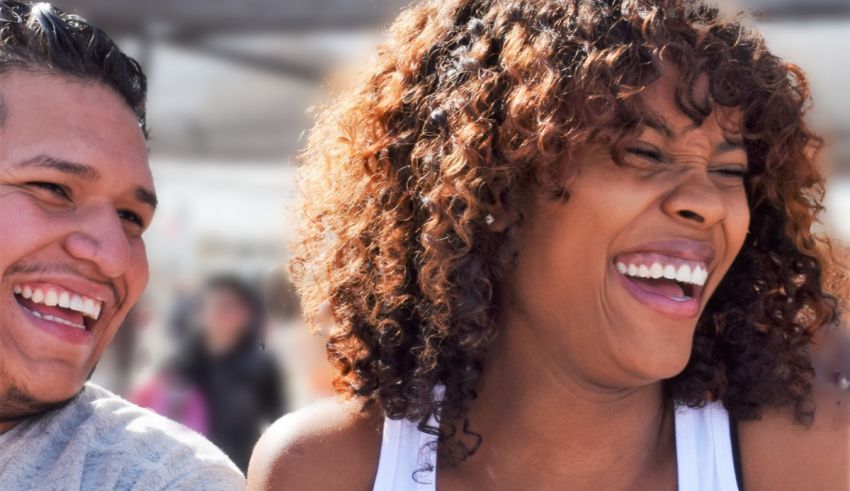 A man and woman laughing at each other.