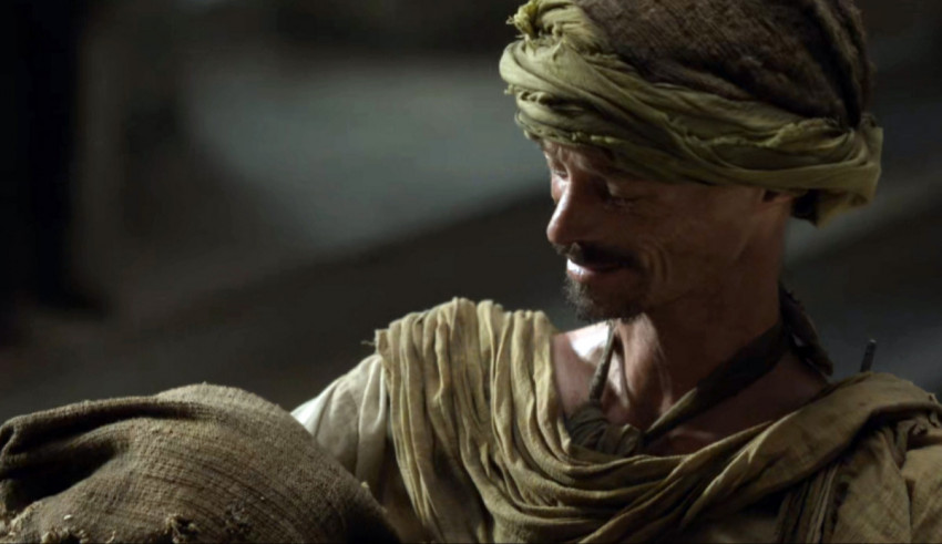 A man in a turban holding a bag.