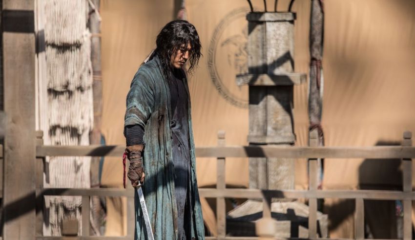 A man in a kimono is holding a sword.