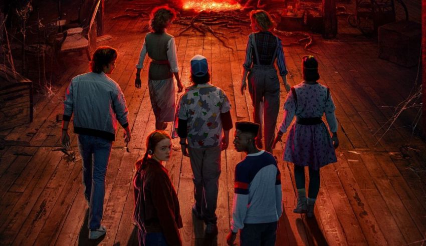 A group of people standing in front of a fireplace.