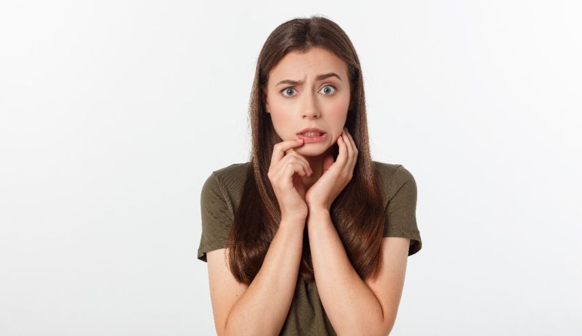A young woman with her hands on her face.