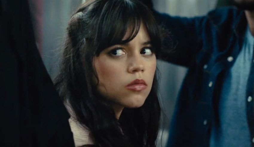 A woman with long hair is looking at a man.