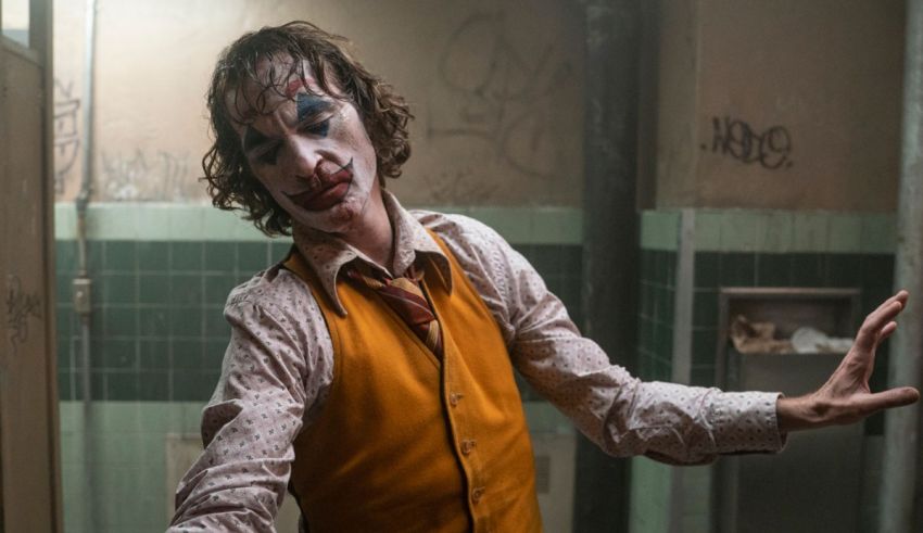 The joker is standing in a bathroom.