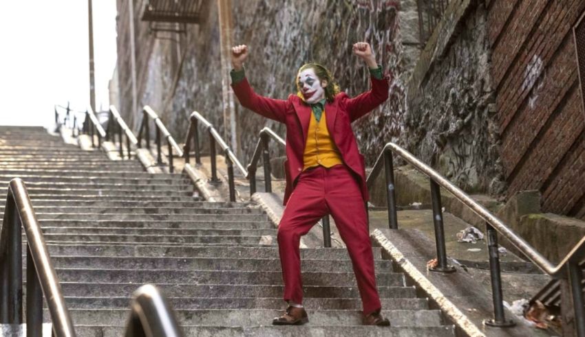 A joker is walking down a set of stairs.