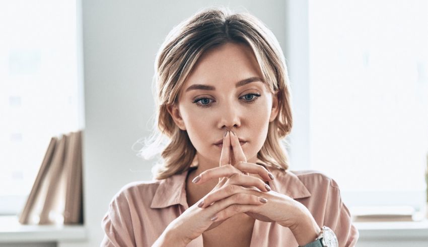 A woman with her finger on her lips.