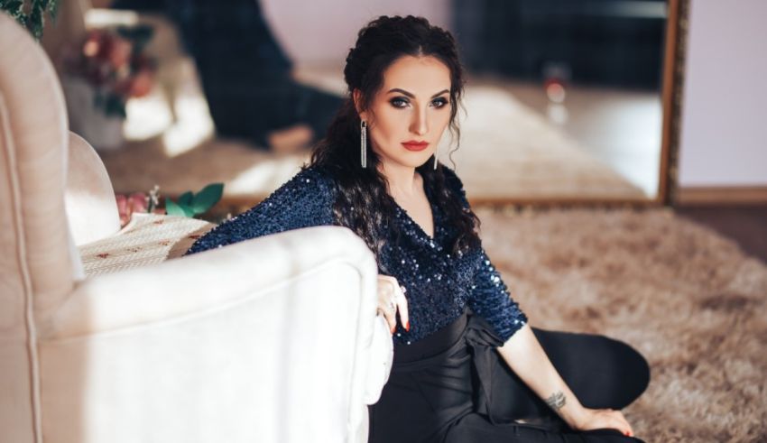 A woman sitting on the floor in front of a mirror.
