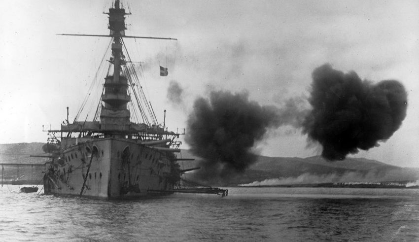 A battleship with smoke coming out of it.